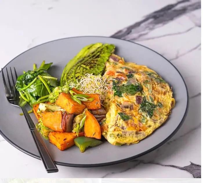 Plated veggie omelette with avocado and sweet potato